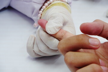 Checking blood sugar level with a glucose meter during a finger prick test.