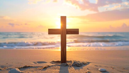 a wooden cross on a sandy beach during sunset