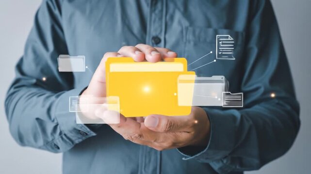 Person holding a glowing yellow file folder with digital folders around