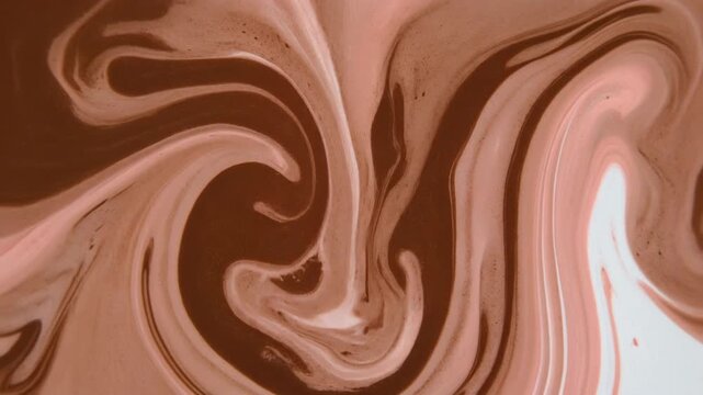 Swirling patterns of rich chocolate and creamy white liquid creating a mesmerizing abstract texture