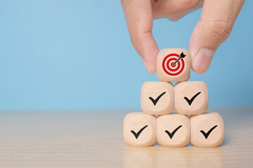 Corporate regulatory and compliance. Goals achievement and business success. Project and goals tracking. Task completion. Managing project timeline. wooden cube with tick and target achievement icon