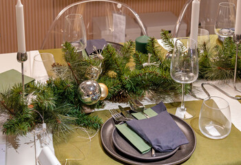 Table set up with festive Christmas ornaments in modern dining room interior