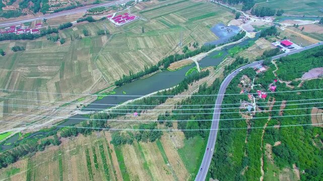 High Voltage Power Tower Over Rural Agricultural Landscape Aerial View