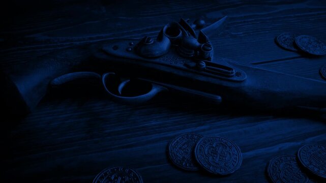 Pistol And Gold Coins On Table In The Dark
