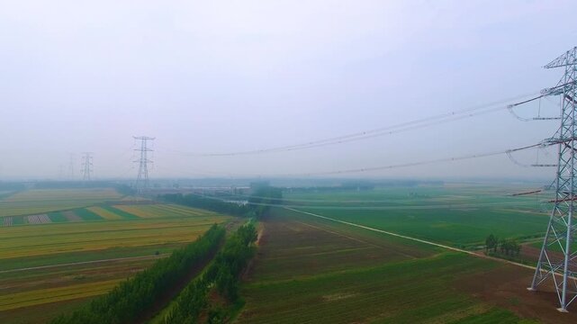 High Voltage Power Towers Over Agricultural Fields