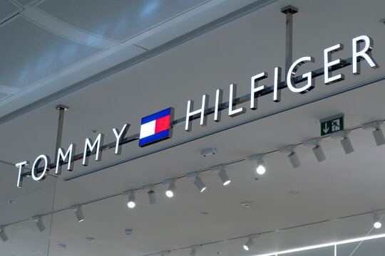 London, UK - December 18 2025: Illustrative editorial Tommy Hilfiger logo illuminated inside fashion retail store with ceiling spotlights