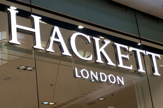London, UK - December 18 2025: Illustrative editorial Hackett London logo illuminated on menswear retail store signage behind glass