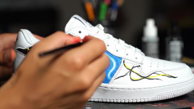 Customizing White Sneakers with Paint and Brush.