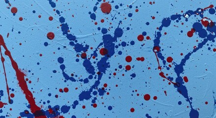 Blue canvas splattered with red and blue drops