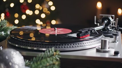 Vintage vinyl record player spinning Christmas music in a cozy, festive room with warm bokeh lights for holiday entertainment concept