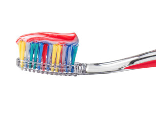 Fresh Start: A close-up view of a toothbrush, adorned with a vibrant burst of toothpaste, a symbol of oral hygiene, sets the stage for a daily routine.