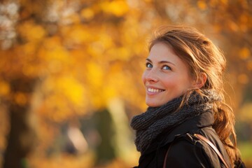 Smiling young woman in autumn outfit outdoors