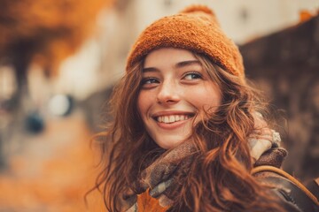 Smiling young woman in autumn outfit outdoors