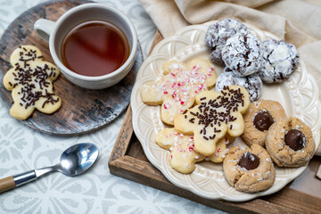 Freshly baked holiday cookies on a plate ready to eat with tea or coffee. Yummy holiday freshly baked treats. 
