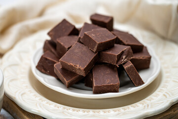 Chocolate fudge, freshly made small squared of pure fudge. Place and coffee or tea setting with a decadent dessert. 