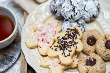 Freshly baked holiday cookies on a plate ready to eat with tea or coffee. Yummy holiday freshly baked treats. 