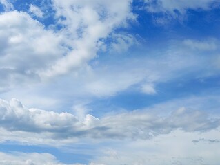 Fototapeta premium Bright Blue Sky With Soft White Clouds Drifting Gently, Creating A Fresh And Open Atmosphere That Feels Calm and Natural