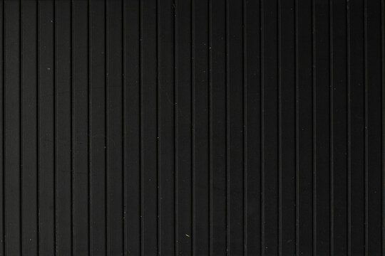Black Vertical Lines Texture. Dark surface with vertical line pattern and minimal texture. Modern industrial background for design projects. - Powered by Adobe