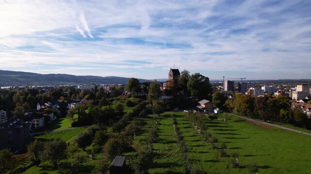 Flying towards the castle of Uster with a apple tree field, Switzerland