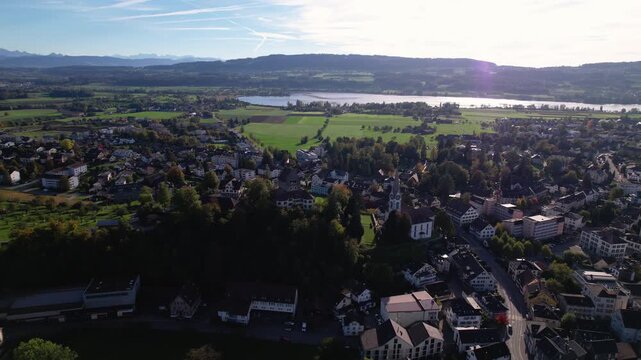 Aerial of a small city with a lake and alps in the background, Uster, Switzerland