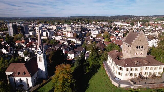 Flying towards a peaceful town with a small castle and church, Uster, Switzerland