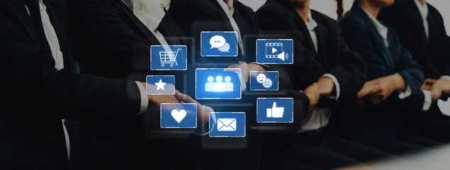 A dynamic digital interface highlights social media and communication icons, symbolizing engagement and collaboration among professionals in an office environment. Trope
