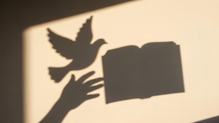 Silhouette of a Hand Holding an Open Book with a Flying Bird Shadow on a Beige Wall