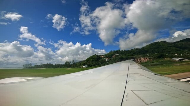 Mahe, Seychelles 14.12.25, Plane taxiing for takeoff, wing view of emirates flight from Seychelles to Dubai, 25fps 001