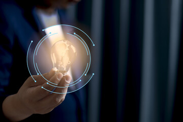 Person holding glowing light bulb with digital elements surrounding it, symbolizing innovation and technology. image conveys futuristic and creative concept