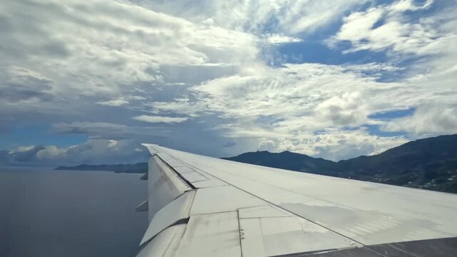Plane landing to Mahe island, wing view of emirates flight from Dubai to Seychelles, 25fps 011