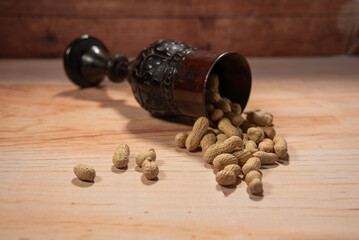 old cup with peanuts in their shells