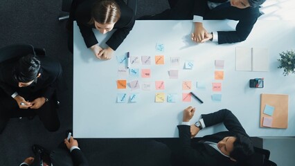 Top down aerial view of professional business team present project and turn around to clap hands and applause to celebrate successful project or financial growth in data analysis graph. Directorate.