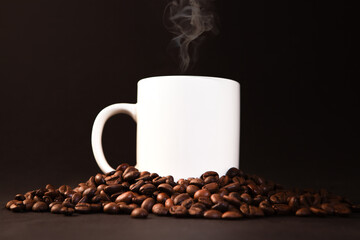 Coffee cup and coffee beans on a black background, close up