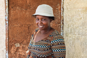 village happy african woman portrait, outdoors in the nature ,at home wall behind
