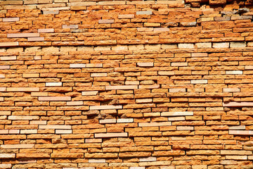 Textured Orange Brick Wall with Various Patterns and Shapes