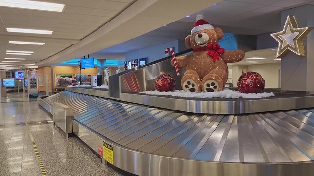 Christmas Decorations at Anchorage Airport Baggage Claim. Interior of Anchorage International Airport with Christmas decorations creating warm festive mood in winter travel season.