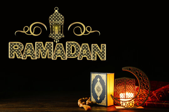Arabic candle holder with glowing candle, Quran and tasbih on dark background