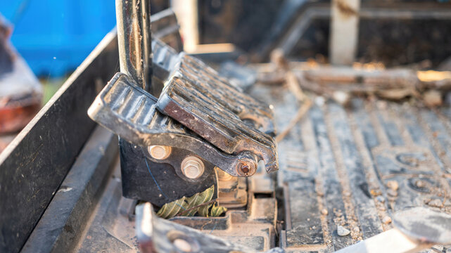 Close-up at gas pedal or throttle foot step of backhoe excavator vehicle. Industrial vehicle object part photo. Selective focus.