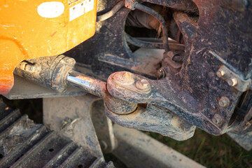 Close-up at hydraulic piston cylinder part of backhoe or tractor bucket arm, equipment to provide...