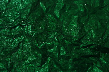 Dark Green Crumpled Paper Texture with Water Droplets and Dramatic Highlights