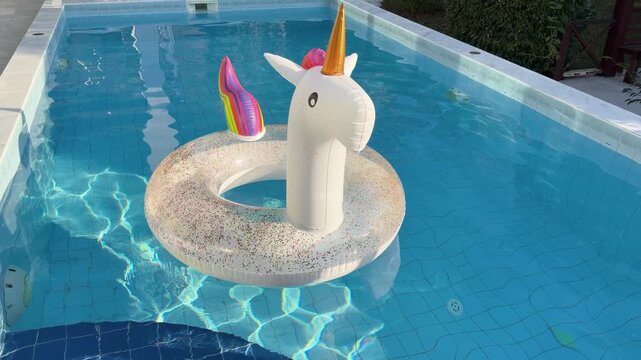 Unicorn Inflatable Gently Floating in Sunny Swimming Pool