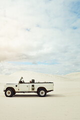 Fototapeta premium Off road truck, desert and adventure on dunes with sky, space or landscape for travel in summer. Vehicle, outdoor or drive in nature, transport or explore on all terrain trip, tourism or ride on sand