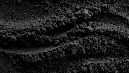 Dark textured soil surface close-up