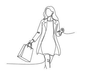 Stylish woman walking with shopping bag in hand
