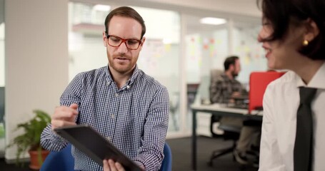 Business team discusses project ideas in office with digital device during work hours and shares insights on strategies and goals