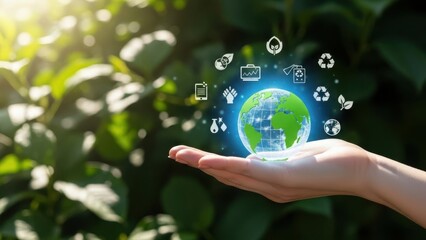 Hand holding a glowing blue eco friendly globe with various icons floating around it in a sunny natural setting