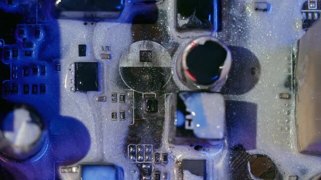 Paint spill. Mainboard chip. Defocused blue purple neon color electronic board water on abstract acrylic light digital art background.