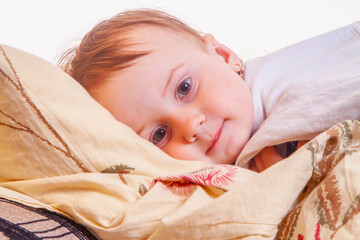 Authentic childhood scene capturing alert baby during evening routine.