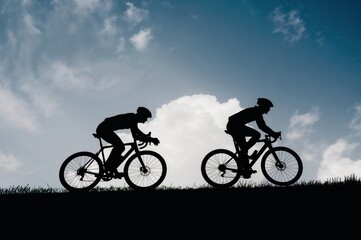 Obraz premium High contrast black silhouette of bicycle riders ascending hill illustrating teamwork determination and healthy lifestyle activity outdoors.