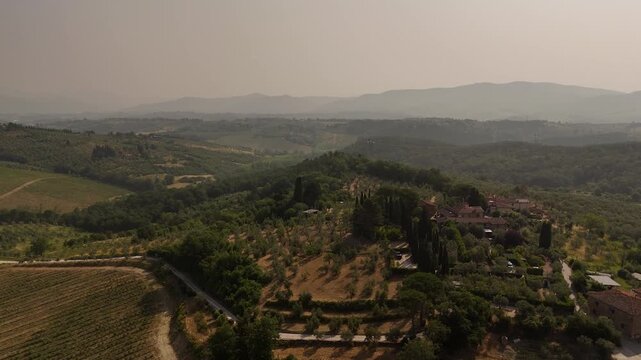Aerial views of houses on a hill in Impruneta near Florence, Italy, featuring the rolling hills of the scenic Tuscan landscape. On a beautiful summers day.